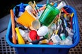 overfilled recycling bin with various plastic items