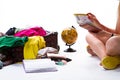 Overfilled suitcase near sitting girl. Royalty Free Stock Photo