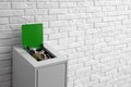 Overfilled trash bin near wall, space for text. Recycling concept