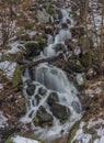 Overflow small creek with waterfall in Krusne mountains