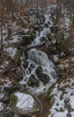 Overflow small creek with waterfall in Krusne mountains