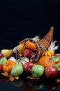 An overflowing cornucopia on a black background Royalty Free Stock Photo