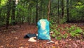 overflowing garbage bag in the forest Royalty Free Stock Photo