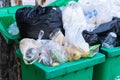 Overflowing garbage bins with household waste