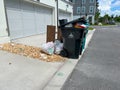 Overflowing garbage cans by a townhouse in Orlando, Florida Royalty Free Stock Photo