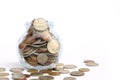 Overflowing jar of International coins on white background with copy space Royalty Free Stock Photo