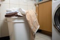 overflowing laundry basket in a bathroom