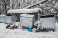 Overflowing metal containers with garbage.scattered debris,pollution of the environment