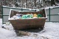 Overflowing metal containers with garbage.scattered debris,pollution of the environment