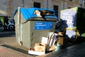 Overflowing paper recycling bin in a street in Granada