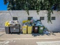 Overflowing public trash containers in the streets of Alghero, Italy