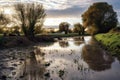 overflowing river banks near submerged fields