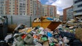 Overflowing trash in the background of a high-rise buildings