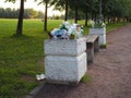 Overflowing waste bins in the park full of all sort of trash. People leave behind garbage.