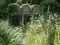 Overgrown grave stone in a cemetery Royalty Free Stock Photo