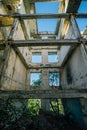 Overgrown ruins of house or industrial building, green post-apocalypse concept Royalty Free Stock Photo