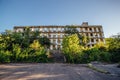 Overgrown ruins of house or industrial building, green post-apocalypse concept Royalty Free Stock Photo