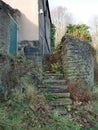 Overgrown stone steps to abandoned cottage