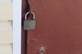 overhang lock hangs on the red iron door Royalty Free Stock Photo