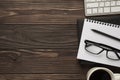 Overhead above photo of office items keyboard diary pencil eyeglasses coffee isolated brown wooden backdrop with place for text