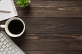 Overhead above view photo of coffee copybook succulent green plant keyboard on dark textured backdrop