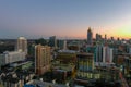 overhead aerial shot of the office buildings and skyscrapers with cars driving on the street and roads lined with trees in Atlanta