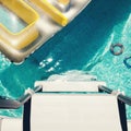 Overhead birdseye view of backyard swimming pool with toys