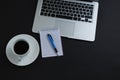 Black coffee, pen, notepad and laptop on black background Royalty Free Stock Photo