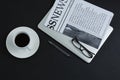 Black coffee, spectacles, pen, laptop and newspaper on black background Royalty Free Stock Photo