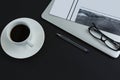 Black coffee, spectacles, pen, laptop and newspaper on black background Royalty Free Stock Photo