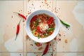 overhead of a bowl with a whole chili pepper on the side