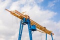 Overhead building hoist crane on a background of blue sky with clouds Royalty Free Stock Photo