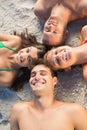 Overhead of cheerful friends lying together in a circle Royalty Free Stock Photo