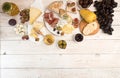 Overhead of cheese plate with pieces moldy cheese, prosciutto, p Royalty Free Stock Photo
