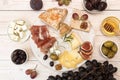 Overhead of cheese plate with pieces moldy cheese, prosciutto, p Royalty Free Stock Photo