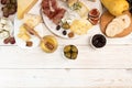 Overhead of cheese plate with pieces moldy cheese, prosciutto, p Royalty Free Stock Photo