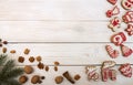 Overhead of Christmas New Year holiday background. Red gingerbread cookies deer and elk, nuts and fir branch tree on white wooden Royalty Free Stock Photo