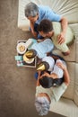 Overhead closeup of a little mixed race boy blowing the candles on a cake at a birthday party with his little brother Royalty Free Stock Photo