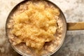 Closeup of Porridge with Mashed Fruit and Cinammon in Saucepan