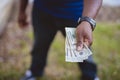 Overhead closeup shot of a person holding three twenty dollar bills with a blurred background Royalty Free Stock Photo