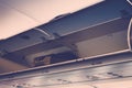 Overhead compartment in commercial airplane .( Filtered image pr Royalty Free Stock Photo