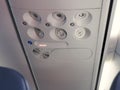 Overhead console in the modern passenger aircraft. Air conditioner button and lighting switch. Royalty Free Stock Photo