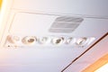 Overhead console in the modern passenger aircraft. air conditioner button and lighting switch, flight attendant call buttons Royalty Free Stock Photo