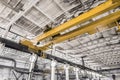 Overhead construction equipment crane in an industrial plant, background production workshop