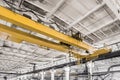 Overhead construction equipment crane in an industrial plant, background production workshop