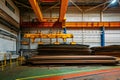 Overhead crane with electromagnetic beam grippers loading steel sheets Royalty Free Stock Photo
