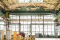 Overhead crane in engineering plant shop. Industrial metalwork production hall and warehousing workshop.