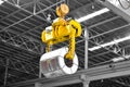 Overhead crane lift up steel coil with tong in wearhouse. Steel coils handling equipment. Steel warehouse and logistics operations Royalty Free Stock Photo