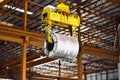 Overhead crane lift up steel coil with tong in wearhouse. Steel coils handling equipment. Steel warehouse and logistics operations