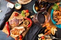 Overhead of dinner table. Assorted delicious grilled barbecue me Royalty Free Stock Photo